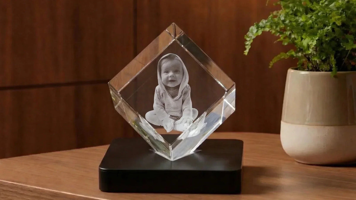 Gravure laser 3D dans un bloc de verre, pausé sur un socle lumineux à LED.