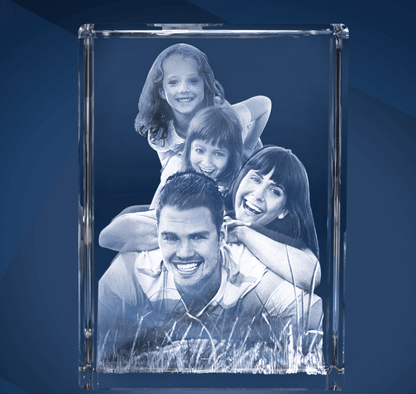 Bloc de Verre Géant Portrait - Gravure Laser 3D d'un couple avec deux enfants allongés dans l'herbe.